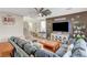 Inviting living room with a large sofa, TV, and staircase at 10004 Pasque Flower Ct, Las Vegas, NV 89178