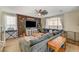 Comfortable living room with a large sectional sofa, ceiling fan, and modern decor at 10004 Pasque Flower Ct, Las Vegas, NV 89178