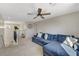 Bright loft area with neutral carpet, modern ceiling fan, and comfortable blue sofa at 10004 Pasque Flower Ct, Las Vegas, NV 89178