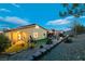 Backyard showcasing a covered patio and landscaped yard with a view of the home's exterior at 10125 Sequoia Falls Pl, Las Vegas, NV 89149