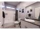 Bright bathroom featuring a shower-tub combo and a granite countertop vanity at 10125 Sequoia Falls Pl, Las Vegas, NV 89149