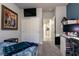 View of a bedroom with carpet, closet, and TV, showcasing the open doorway to the kitchen at 10125 Sequoia Falls Pl, Las Vegas, NV 89149