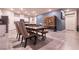 Dining area open to kitchen featuring white cabinets and stainless appliances; table seats up to six at 10125 Sequoia Falls Pl, Las Vegas, NV 89149