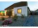 Beautiful home exterior with a brick walkway, desert landscaping and a view of a window at dusk at 10125 Sequoia Falls Pl, Las Vegas, NV 89149
