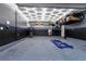 Spacious garage featuring a car lift, and overhead storage racks at 10125 Sequoia Falls Pl, Las Vegas, NV 89149
