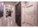 Hallway with tile flooring, wooden barn door, and neutral wall color to complement any decor at 10125 Sequoia Falls Pl, Las Vegas, NV 89149