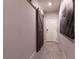 Charming hallway with tile flooring, interior doors and sliding barn door feature at 10125 Sequoia Falls Pl, Las Vegas, NV 89149
