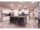 Stylish kitchen with white cabinets, granite countertops, stainless steel appliances, and an island with bar seating at 10125 Sequoia Falls Pl, Las Vegas, NV 89149