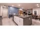 Spacious kitchen island features stainless steel appliances, granite countertops, and ample seating in this open concept space at 10125 Sequoia Falls Pl, Las Vegas, NV 89149