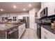 A kitchen featuring white cabinetry, stainless steel appliances and speckled granite countertops at 10125 Sequoia Falls Pl, Las Vegas, NV 89149