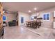 Open living room with modern tile flooring, neutral walls, and dining set under recessed lighting at 10125 Sequoia Falls Pl, Las Vegas, NV 89149