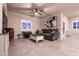 Cozy living room features a ceiling fan, shutters, and comfortable seating with ample natural light at 10125 Sequoia Falls Pl, Las Vegas, NV 89149