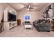 Relaxing living room with a comfortable sofa, entertainment center, and a ceiling fan at 10125 Sequoia Falls Pl, Las Vegas, NV 89149