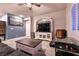 Cozy living room with a large TV, comfortable seating, and a ceiling fan at 10125 Sequoia Falls Pl, Las Vegas, NV 89149