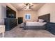 Inviting primary bedroom with plush carpeting, a large TV, and stylish dark furniture at 10125 Sequoia Falls Pl, Las Vegas, NV 89149