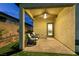 Cozy covered patio area with brick pavers, ceiling fan, and comfortable seating, perfect for outdoor relaxation at 10125 Sequoia Falls Pl, Las Vegas, NV 89149