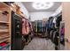 A large walk-in closet featuring ample storage, clothing racks, and a secure safe for valuables at 10125 Sequoia Falls Pl, Las Vegas, NV 89149