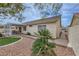 Backyard showcasing desert landscaping, a covered patio, and a side gate at 1022 Atticus Ave, Henderson, NV 89015