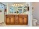 Bathroom with wood cabinet double sink vanity, stylish lighting and large framed mirror at 1022 Atticus Ave, Henderson, NV 89015