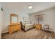 Neutral bedroom with a light-colored wood dresser and a daybed near the window at 1022 Atticus Ave, Henderson, NV 89015