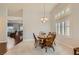 Bright dining room with a wood dining set and large windows with shutter blinds at 1022 Atticus Ave, Henderson, NV 89015