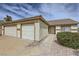 Traditional single-story home with desert landscaping and a three car garage at 1022 Atticus Ave, Henderson, NV 89015