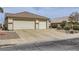 Traditional single-story home with desert landscaping and a three car garage at 1022 Atticus Ave, Henderson, NV 89015