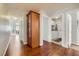 Hallway showcasing hardwood floors, storage cabinet, leading to the laundry and living areas at 1022 Atticus Ave, Henderson, NV 89015