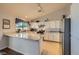 Bright kitchen features white cabinetry, granite counters, track lighting, and a breakfast bar at 1022 Atticus Ave, Henderson, NV 89015