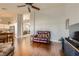 Open-concept living room with hardwood floors connects to kitchen and dining area at 1022 Atticus Ave, Henderson, NV 89015
