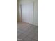 Bedroom features tile flooring and closet with white sliding doors, offering a clean, modern look at 1832 Lewis Ave, Las Vegas, NV 89101