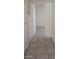 Inviting hallway featuring neutral tile flooring and an open doorway to a brightly lit room at 1832 Lewis Ave, Las Vegas, NV 89101