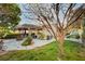 Spacious backyard featuring a covered patio, mature trees, and a well-maintained lawn at 1905 Calle De Espana, Las Vegas, NV 89102