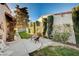 Private backyard with manicured hedges, a stone pathway, and a charming bench seating area at 1905 Calle De Espana, Las Vegas, NV 89102