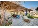 Charming backyard patio with a wooden pergola, comfortable seating, and lush greenery at 1905 Calle De Espana, Las Vegas, NV 89102