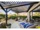 Inviting backyard patio with pergola, comfortable wicker furniture, and lush potted plants; ideal for outdoor living at 1905 Calle De Espana, Las Vegas, NV 89102