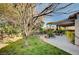 Spacious backyard featuring a covered patio, mature trees, and a well-maintained lawn at 1905 Calle De Espana, Las Vegas, NV 89102