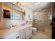 Bright bathroom featuring a walk-in shower with glass door, vanity with white cabinets, and tiled floors at 1905 Calle De Espana, Las Vegas, NV 89102