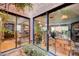Inviting courtyard with rock ground cover, lush plants, and access to the home's interior through sliding glass doors at 1905 Calle De Espana, Las Vegas, NV 89102