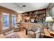 Cozy office space with built-in bookshelves, comfortable seating, and a view to the backyard at 1905 Calle De Espana, Las Vegas, NV 89102