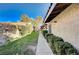Spacious side yard with mature landscaping and a paved walkway offers privacy and curb appeal at 1905 Calle De Espana, Las Vegas, NV 89102