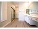 Modern bathroom featuring hardwood floors, vanity and a large closet at 2111 Loro Ct, Las Vegas, NV 89117