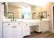 Elegant bathroom featuring double sinks, hardwood floors and ample storage at 2111 Loro Ct, Las Vegas, NV 89117