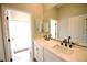 A bathroom with double sinks, white cabinets, and modern black fixtures at 2111 Loro Ct, Las Vegas, NV 89117