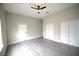 A bright bedroom featuring wood-look floors, ceiling fan, and a closet at 2111 Loro Ct, Las Vegas, NV 89117