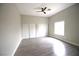 Spacious bedroom with wood look flooring, ceiling fan, and dual closets at 2111 Loro Ct, Las Vegas, NV 89117