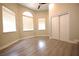 Bedroom with natural light and wood look flooring, featuring double door closet at 2111 Loro Ct, Las Vegas, NV 89117