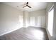Spacious bedroom with light gray walls, modern ceiling fan, and wood-look flooring at 2111 Loro Ct, Las Vegas, NV 89117