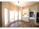 Bright breakfast nook with a modern light fixture and white cabinets with marble countertops at 2111 Loro Ct, Las Vegas, NV 89117