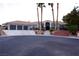 Expansive single-story home showcasing mature palm trees, a 3-car garage, and elegant stone pathway to the front entryway at 2111 Loro Ct, Las Vegas, NV 89117